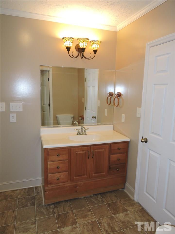 128 Allgood Street Roxboro, NC 27573 - Photo 7 of 17 a bathroom with a sink a vanity and a mirror