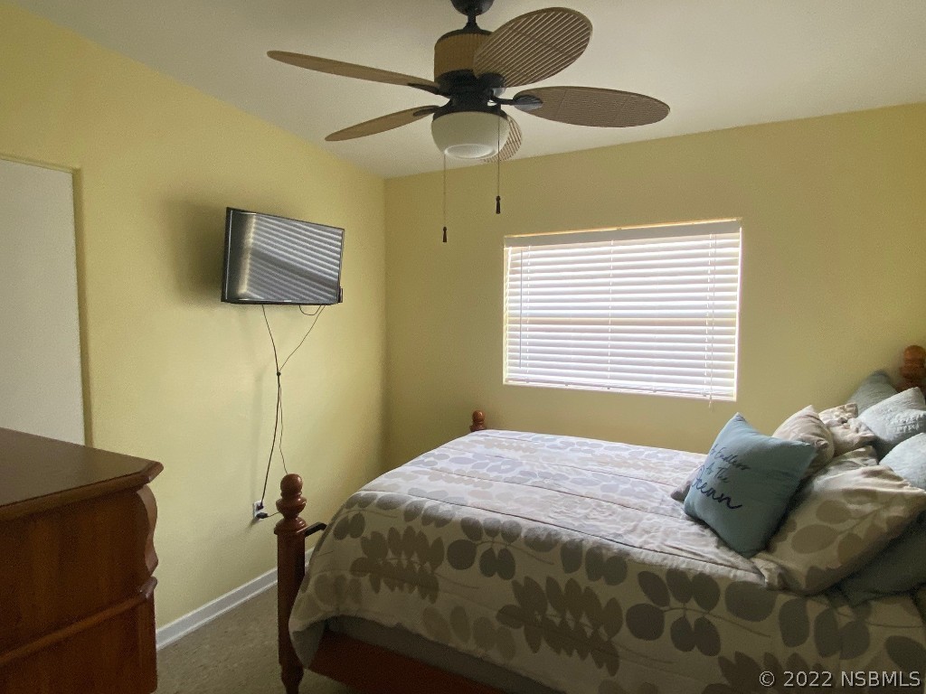 229 Robinson Road New Smyrna Beach, FL 32169 - Photo 12 of 23 a bedroom with a bed and a flat screen tv