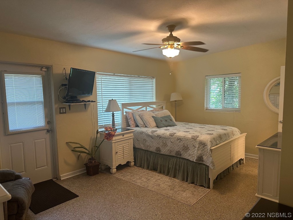 229 Robinson Road New Smyrna Beach, FL 32169 - Photo 15 of 23 a bedroom with a bed and a chandelier
