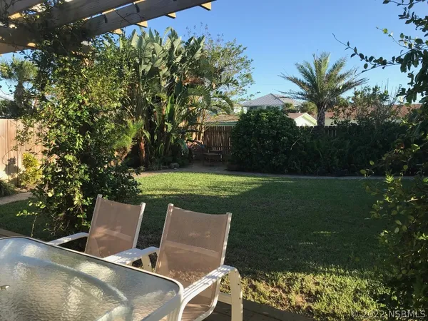a view of a chairs and table in the garden