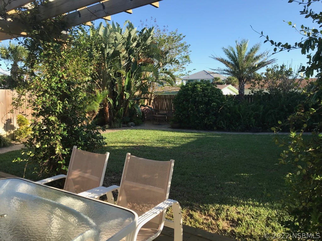 229 Robinson Road New Smyrna Beach, FL 32169 - Photo 21 of 23 a view of a chairs and table in the garden