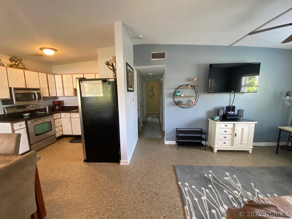 229 Robinson Road New Smyrna Beach, FL 32169 - Photo 5 of 23 a kitchen with stainless steel appliances granite countertop a refrigerator and a stove
