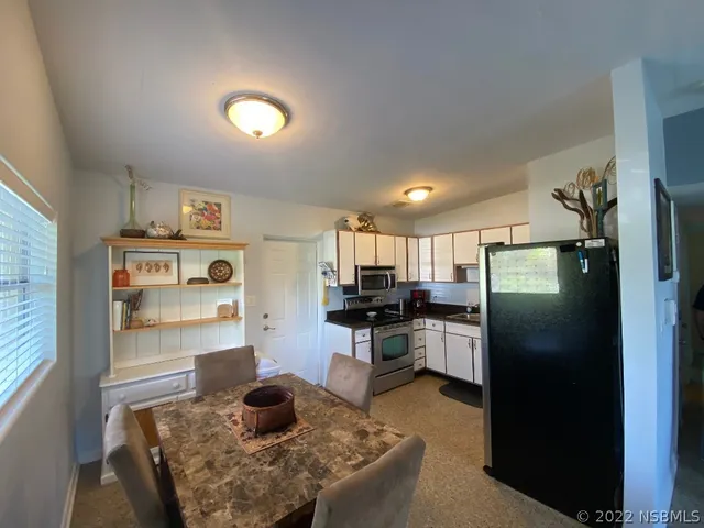 a kitchen with refrigerator and window
