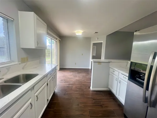 a kitchen with stainless steel appliances granite countertop a sink and dishwasher a stove top oven with wooden floor