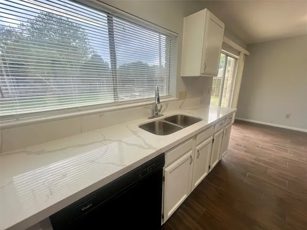 a kitchen with a sink and large window