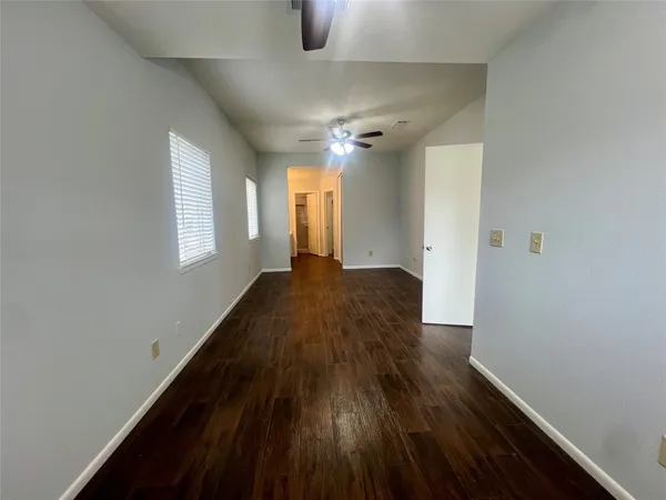 a view of a livingroom with wooden floor and a window