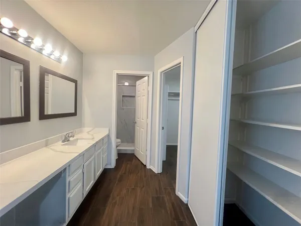 a bathroom with a double vanity sink and a mirror