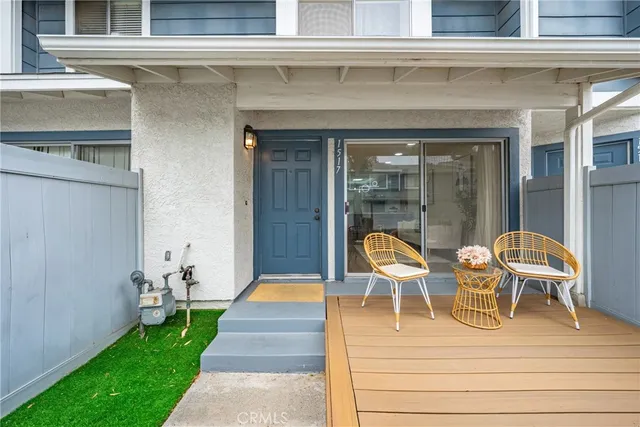 a view of two chairs in patio of the house