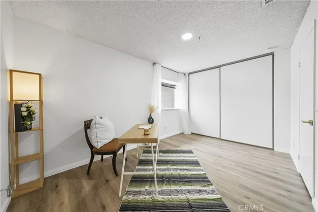 a view of a room with wooden floor and chair