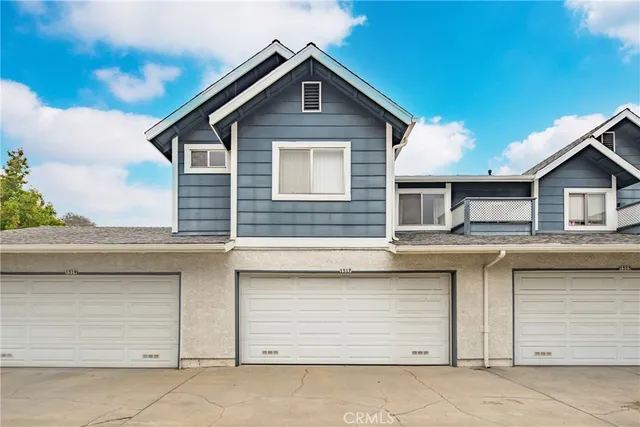 a view of a house with a garage and balcony