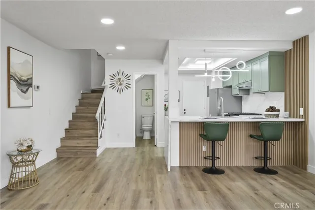 a view of kitchen and hall with wooden floor