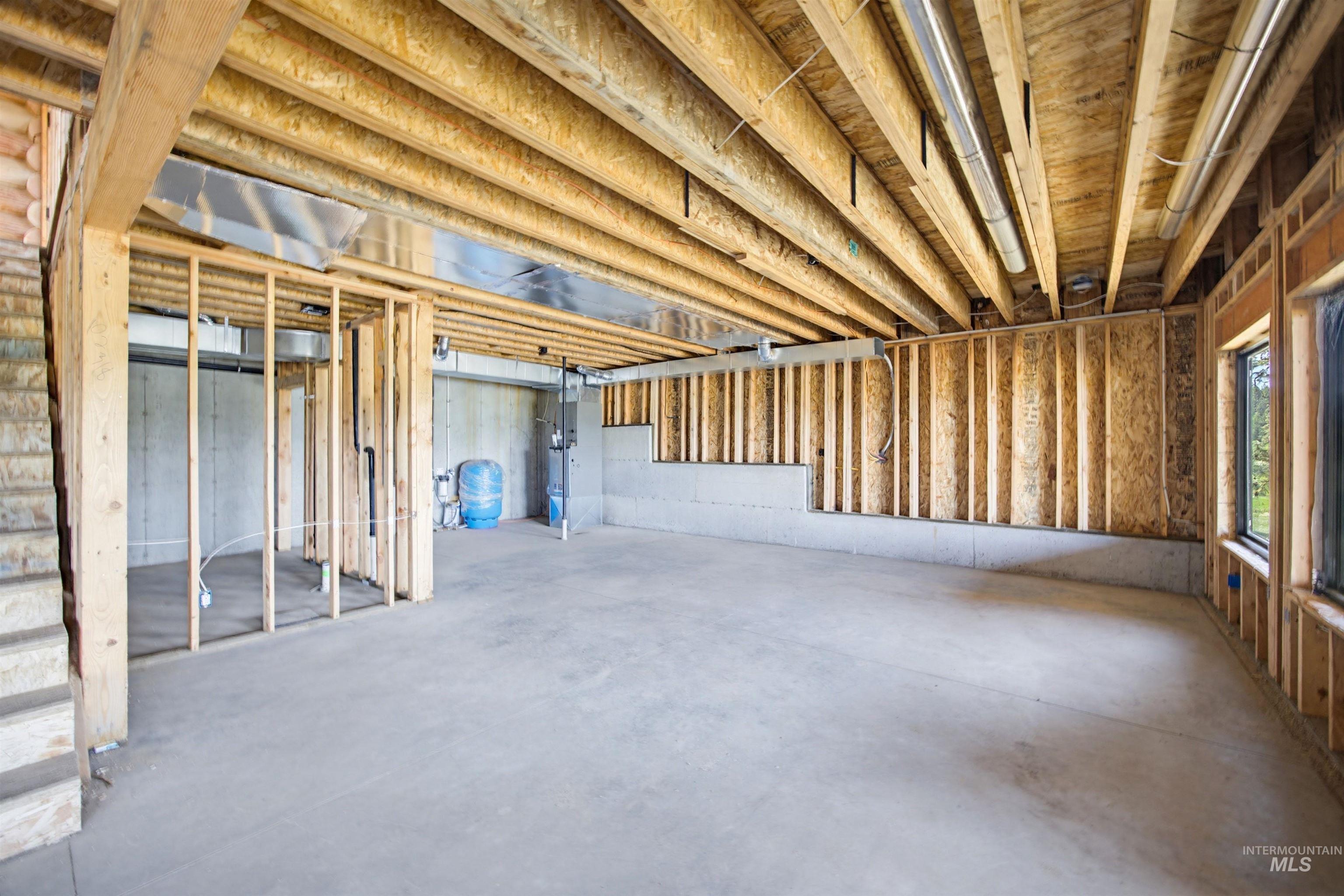 3322 Big Creek Road New Meadows, ID 83654 - Photo 30 of 50 Unfinished basement featuring exposed wood joists, concrete flooring, framed interior walls, and two visible windows
