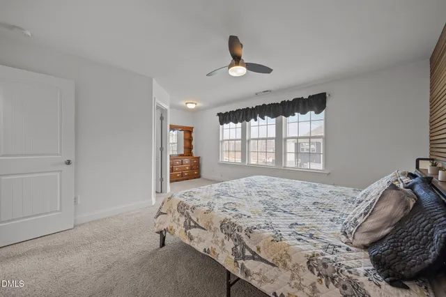 a open kitchen with granite countertop a white stove top oven and cabinets