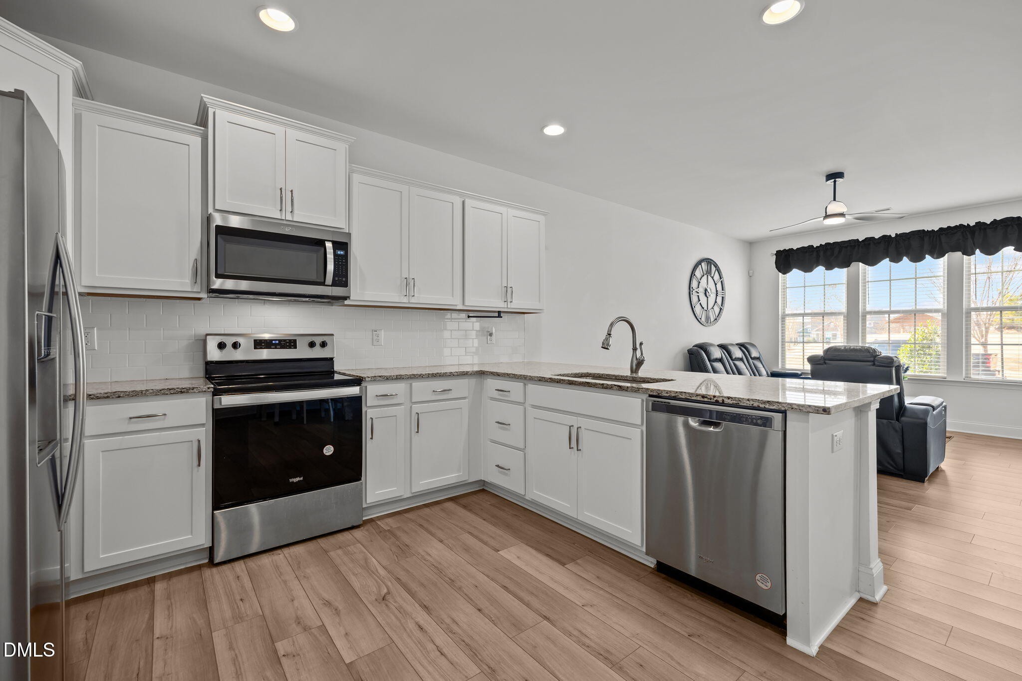 6173 Taylor Road Wendell, NC 27591 - Photo 5 of 31 a kitchen with granite countertop a sink cabinets and stainless steel appliances