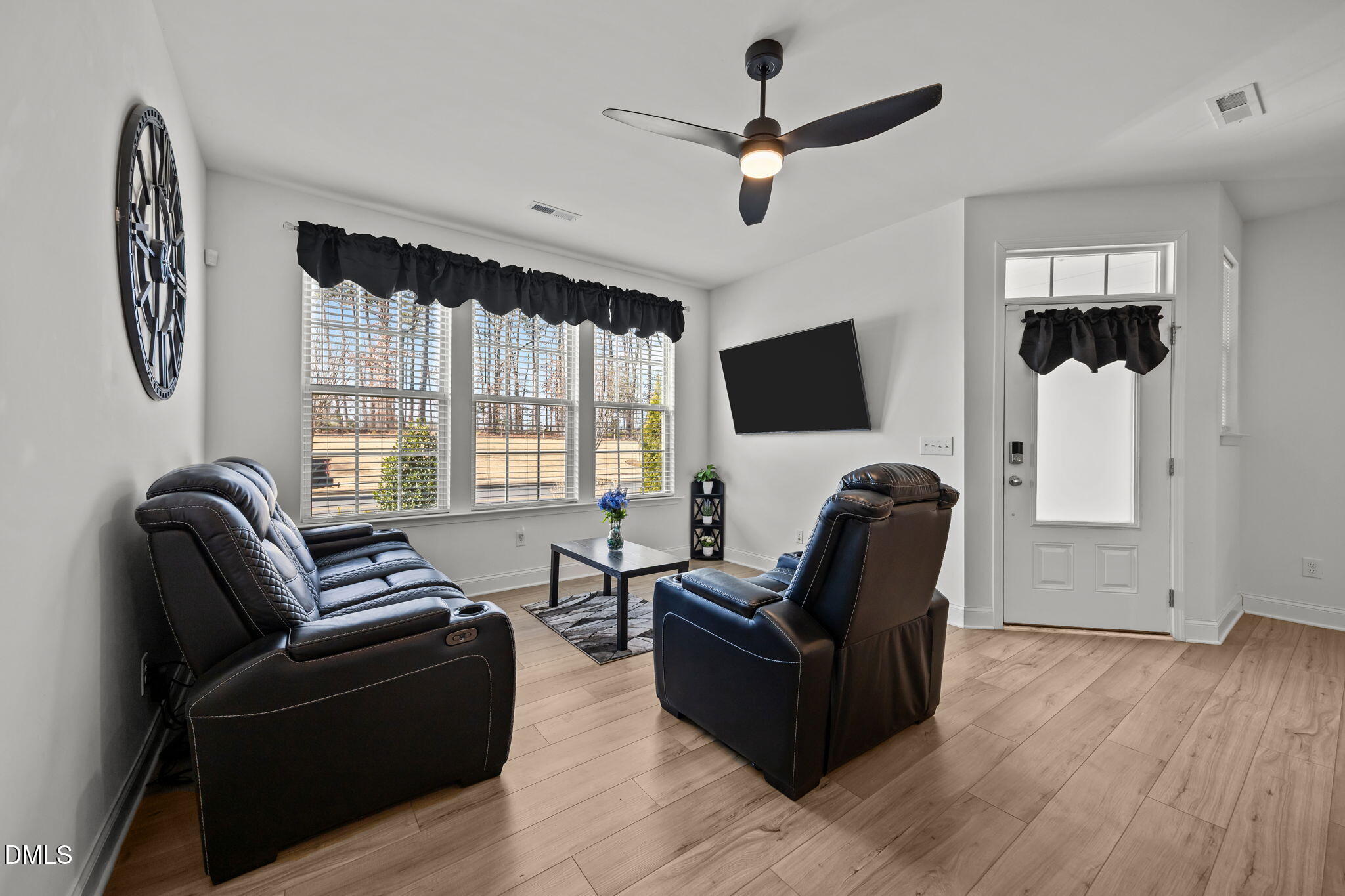 6173 Taylor Road Wendell, NC 27591 - Photo 6 of 31 a living room with furniture a ceiling fan and a window