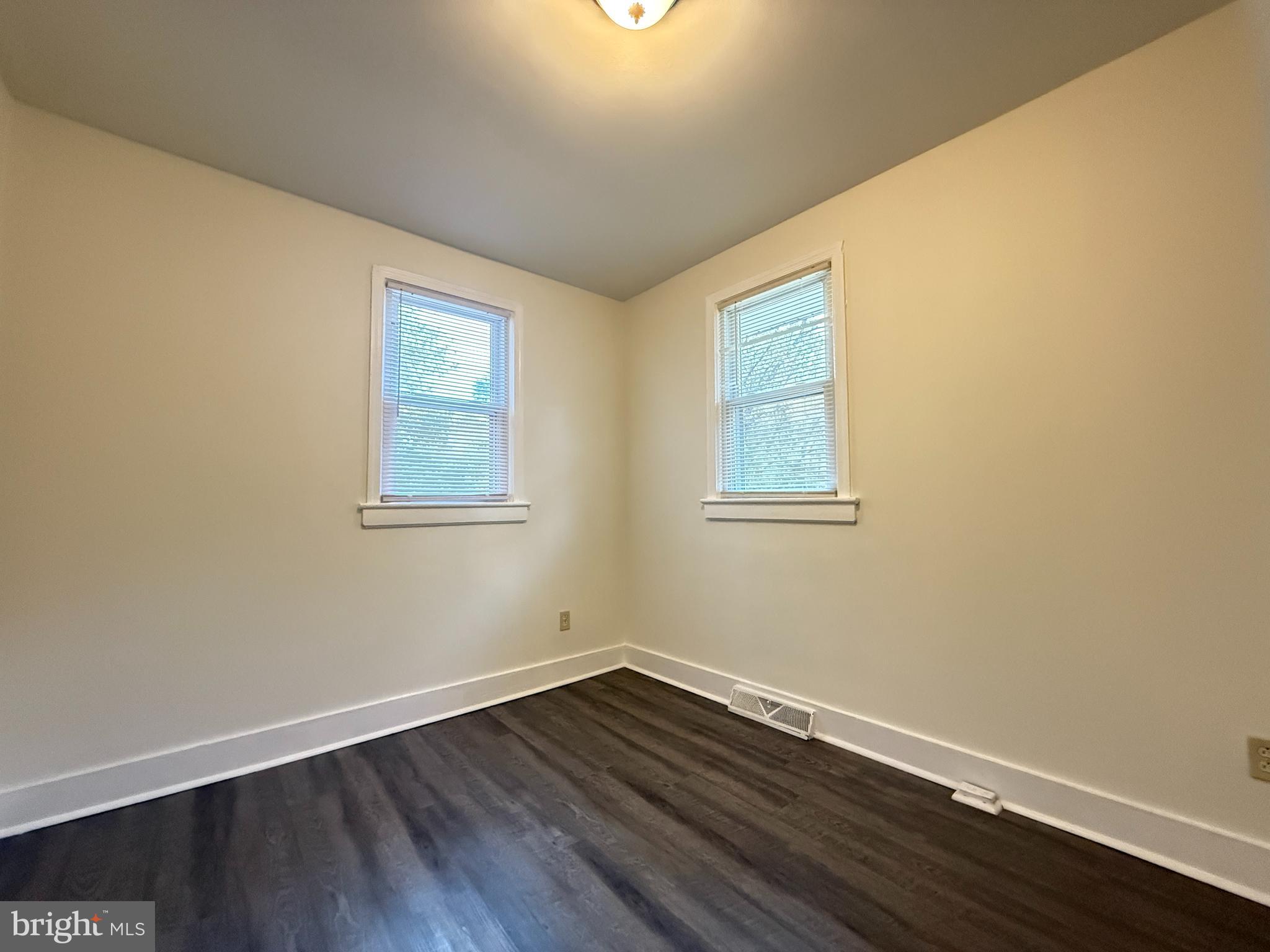 13701 Old Indian Head Road Brandywine, MD 20613 - Photo 17 of 18 a view of an empty room with wooden floor and a window