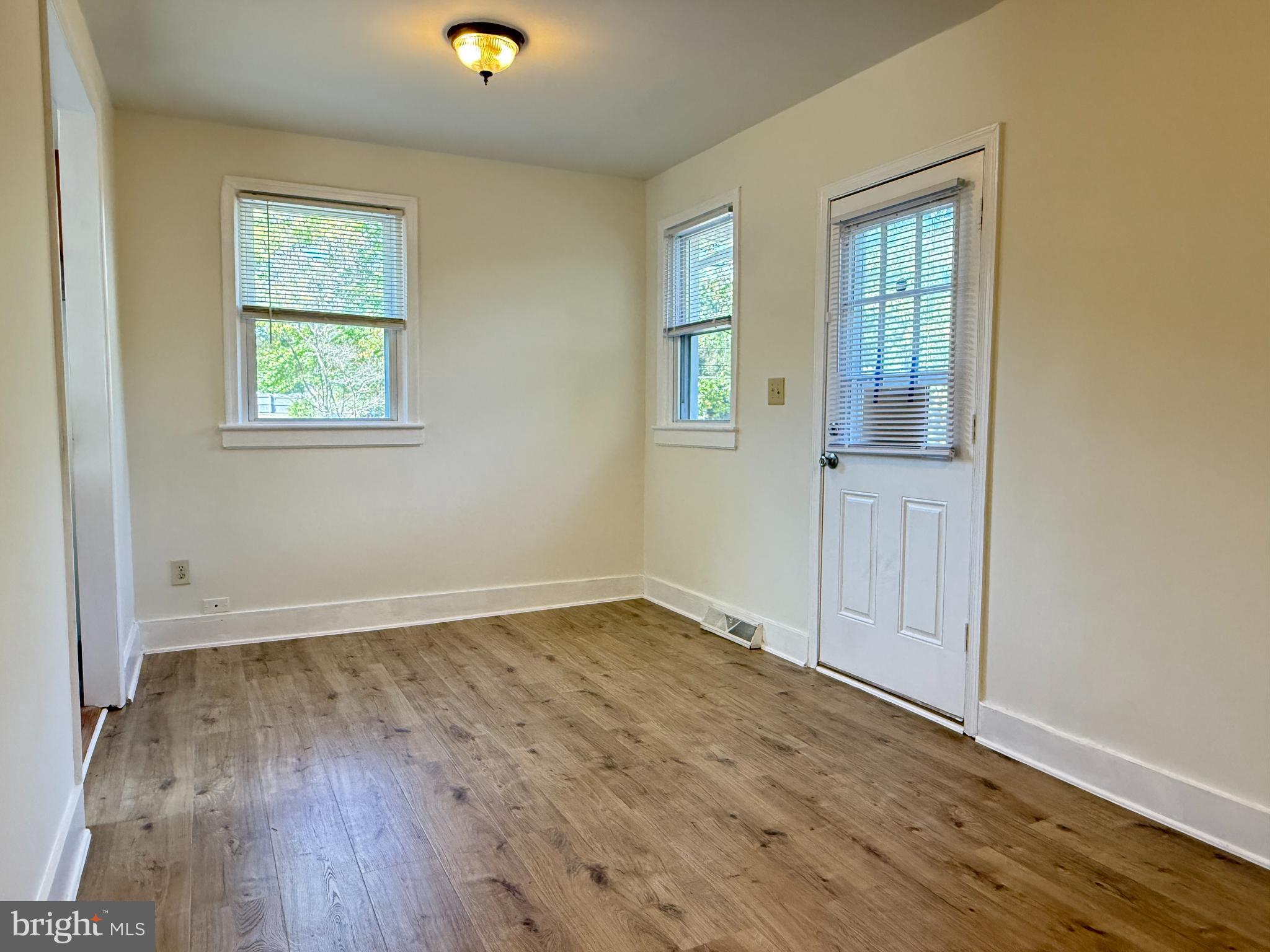 13701 Old Indian Head Road Brandywine, MD 20613 - Photo 10 of 18 an empty room with wooden floor and windows