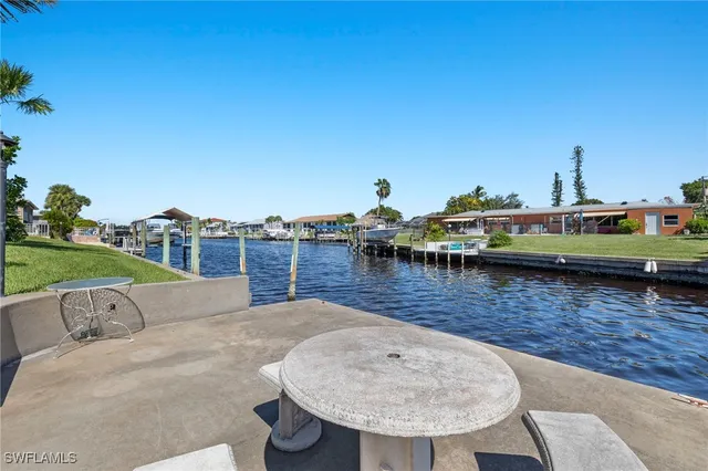a view of a swimming pool with a table and chairs