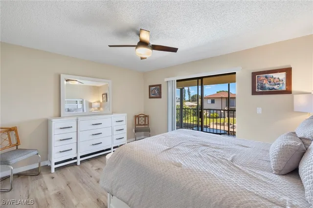 a bedroom with a bed dresser and a window
