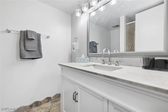 a bathroom with a sink and a mirror