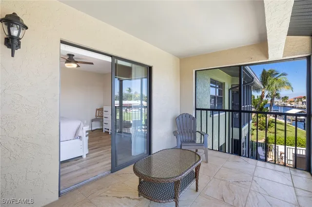 a living room with furniture a rug and a potted plant