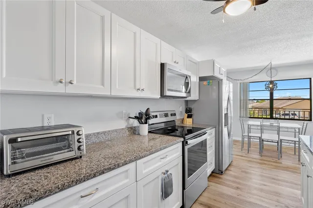 a kitchen with granite countertop a stove a sink and a granite counter tops