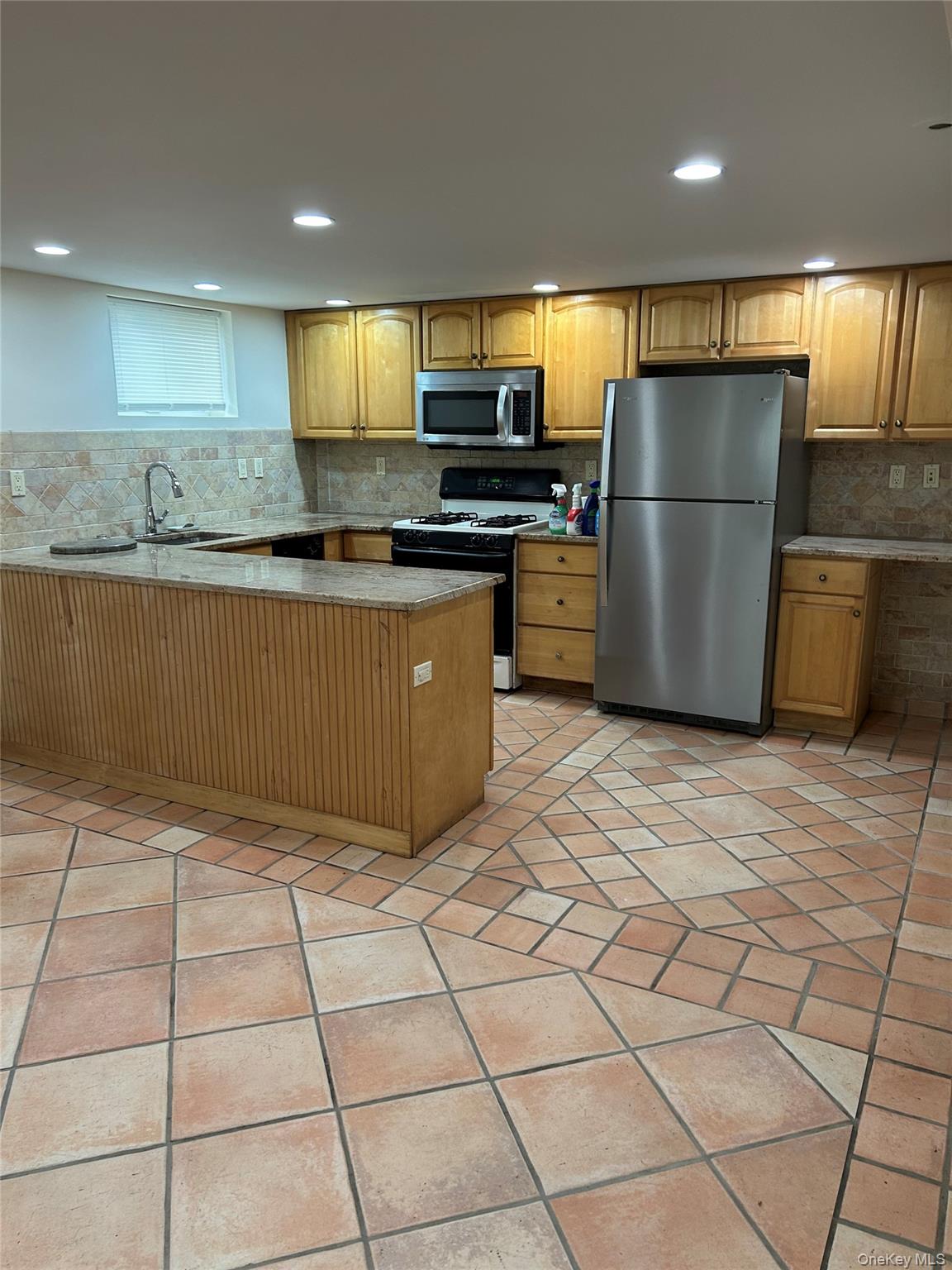 37 Memorial Drive, Unit 37B Chappaqua, NY 10514 - Photo 3 of 7 a kitchen with stainless steel appliances granite countertop a refrigerator a stove a sink a microwave and a refrigerator