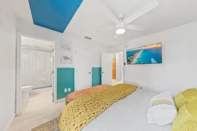 a bedroom with a bed and a chandelier