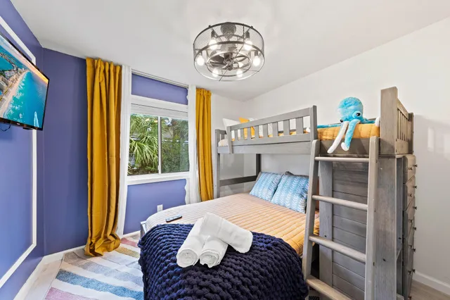 a bedroom with a bed and a chandelier