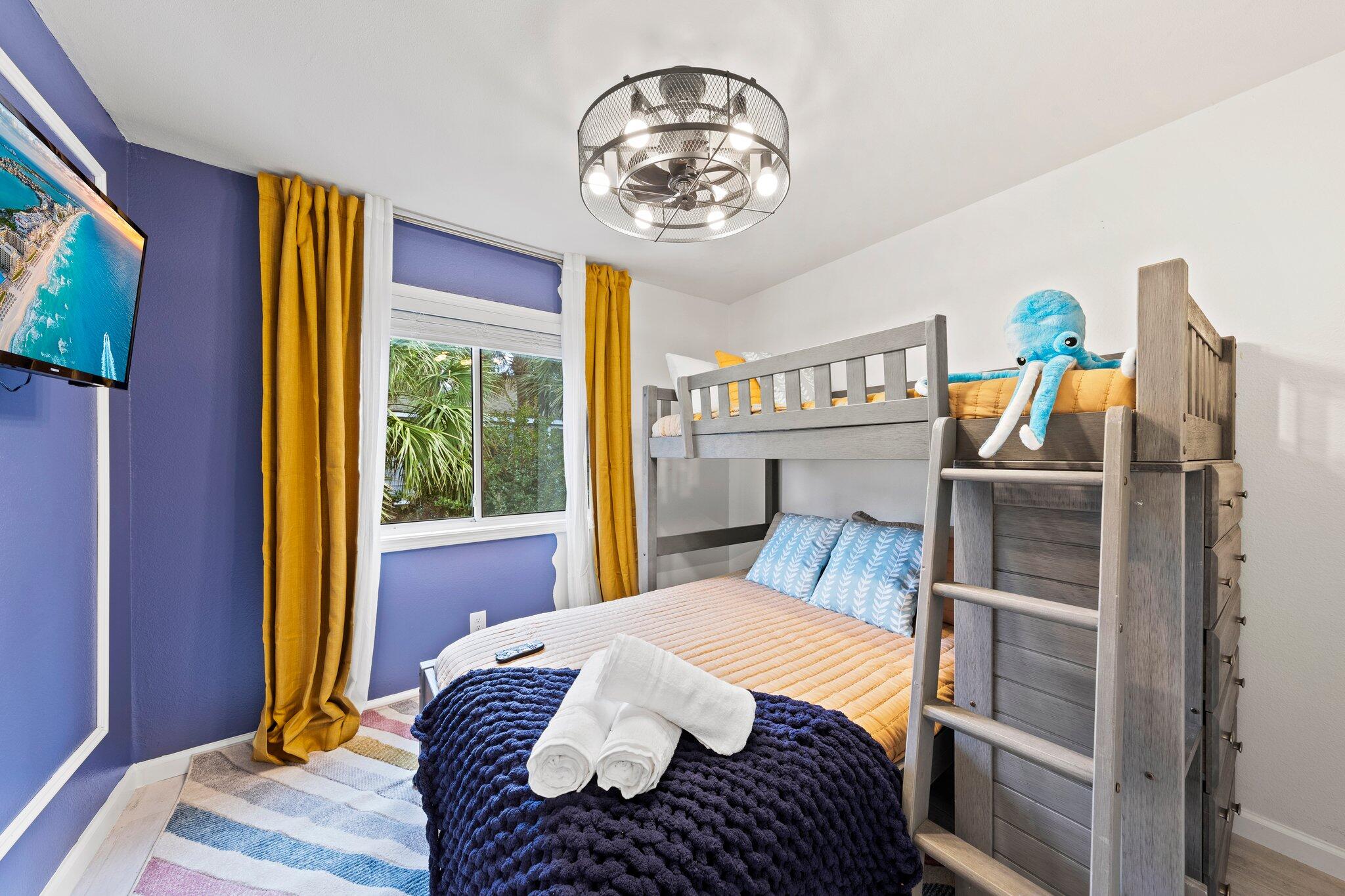 940 Highway 98, Unit 36 Destin, FL 32541 - Photo 13 of 31 a bedroom with a bed and a chandelier