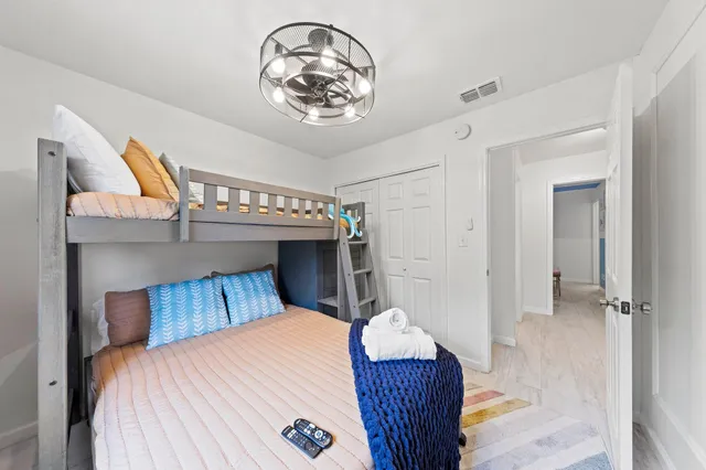 a bedroom with a bed and a chandelier