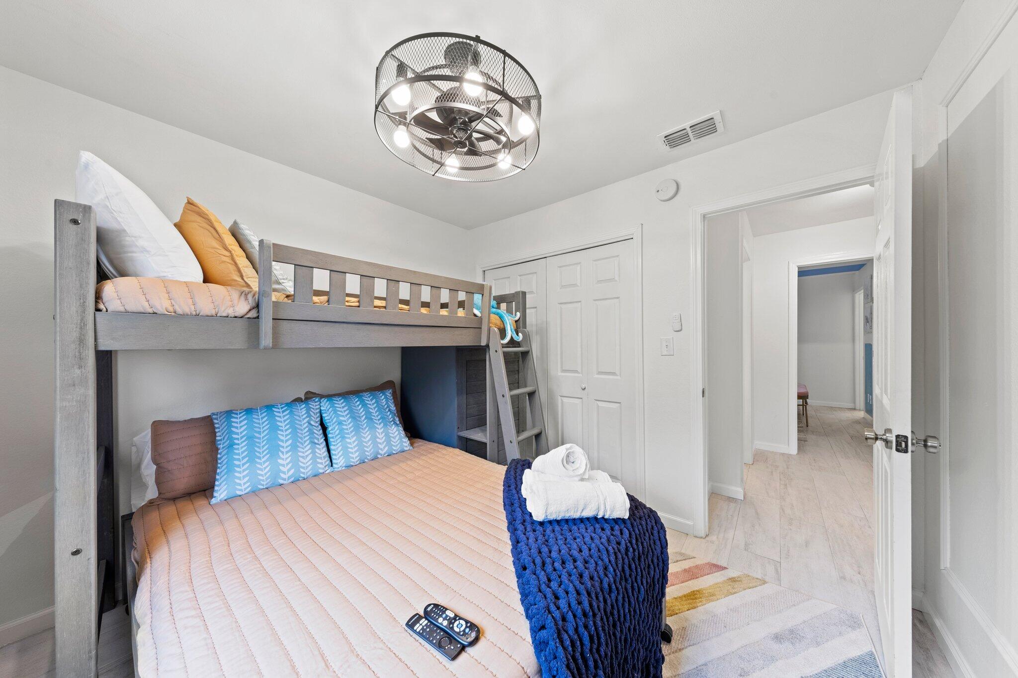 940 Highway 98, Unit 36 Destin, FL 32541 - Photo 14 of 31 a bedroom with a bed and a chandelier