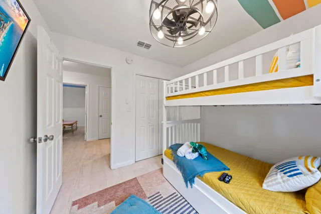 a bedroom with a bed and a chandelier