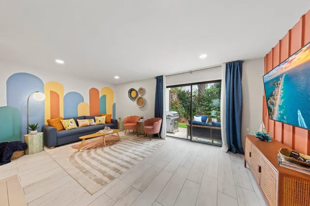 a bed room with furniture and a flat screen tv