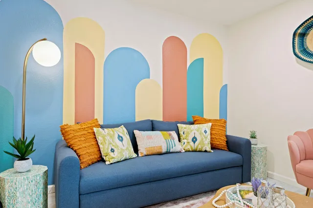 a living room with furniture and a potted plant