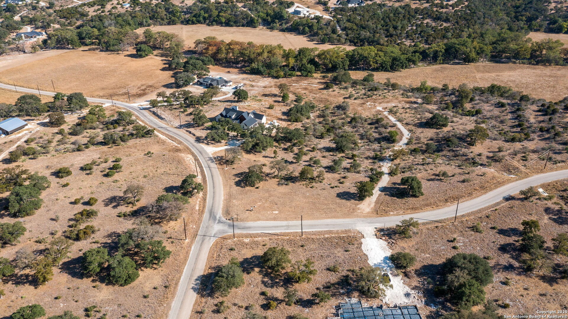 Lot 69 Sabinas Springs Road Boerne, TX 78006 - Photo 37 of 54 a view of a yard covered with snow on the road