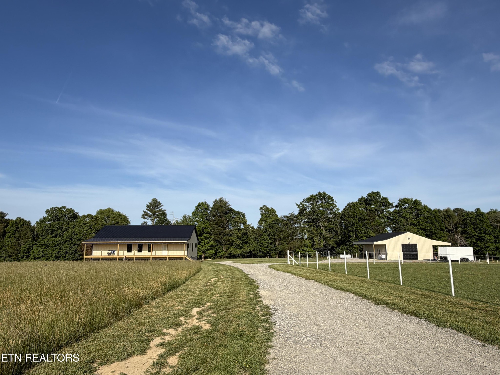 110 Don Conatser Road Allardt, TN 38504 - Photo 1 of 38 a view of a big yard with a swimming pool and trees in the background