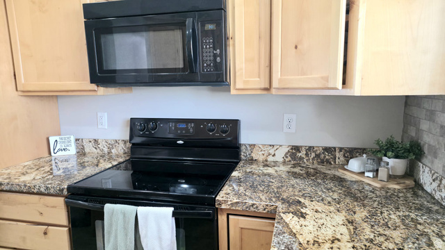 1437 925 South Vernal, UT 84078 - Photo 6 of 47 Kitchen featuring light wood cabinetry, a black over-the-range microwave, and a black electric range