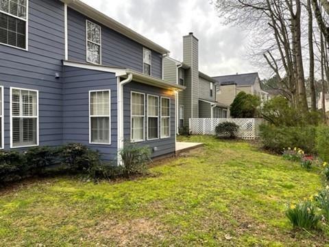 3324 Benthollow Lane Duluth, GA 30096 - Photo 15 of 16 a view of a brick house with a yard plants and large tree