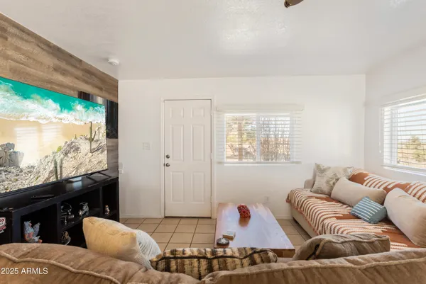 a living room with furniture and a book shelf