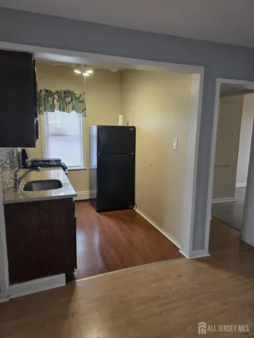 a kitchen with a sink and a refrigerator