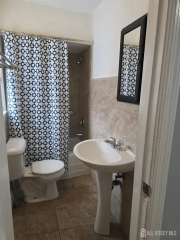 a bathroom with a sink toilet and a mirror