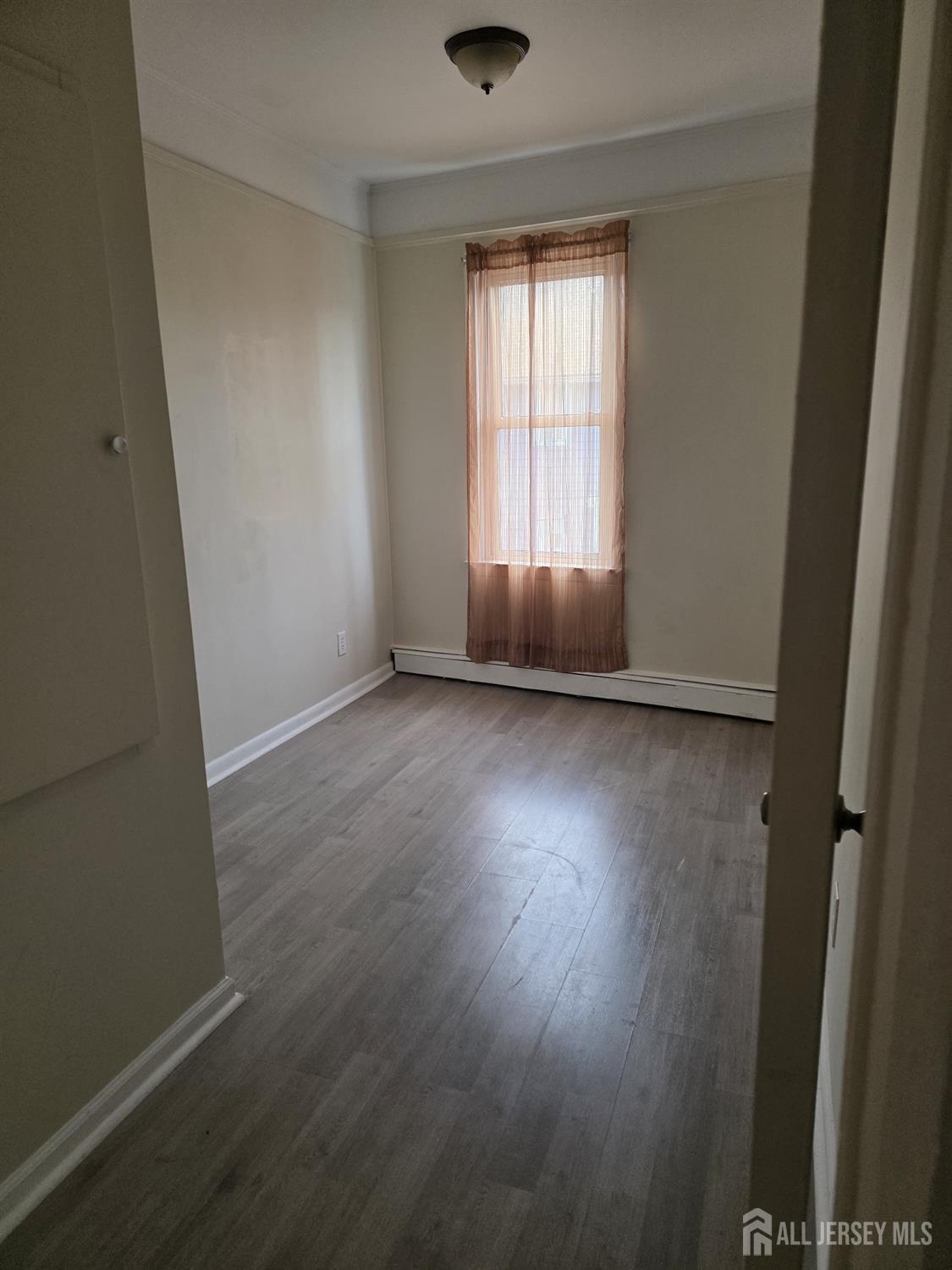 604 Freeman Street, Unit 2 Lyndhurst, NJ 07071 - Photo 8 of 8 an empty room with wooden floor and windows