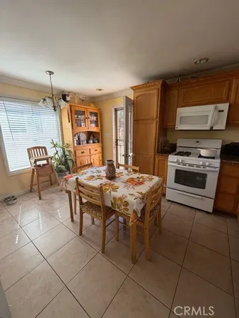 a kitchen with a table chairs and a stove