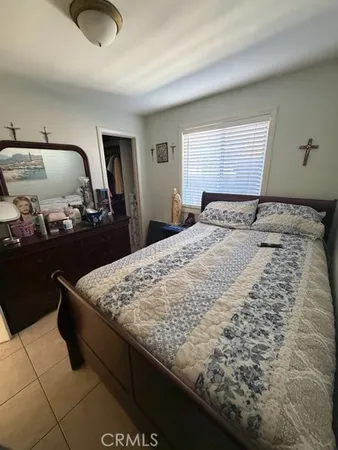 a bedroom with a bed and dresser