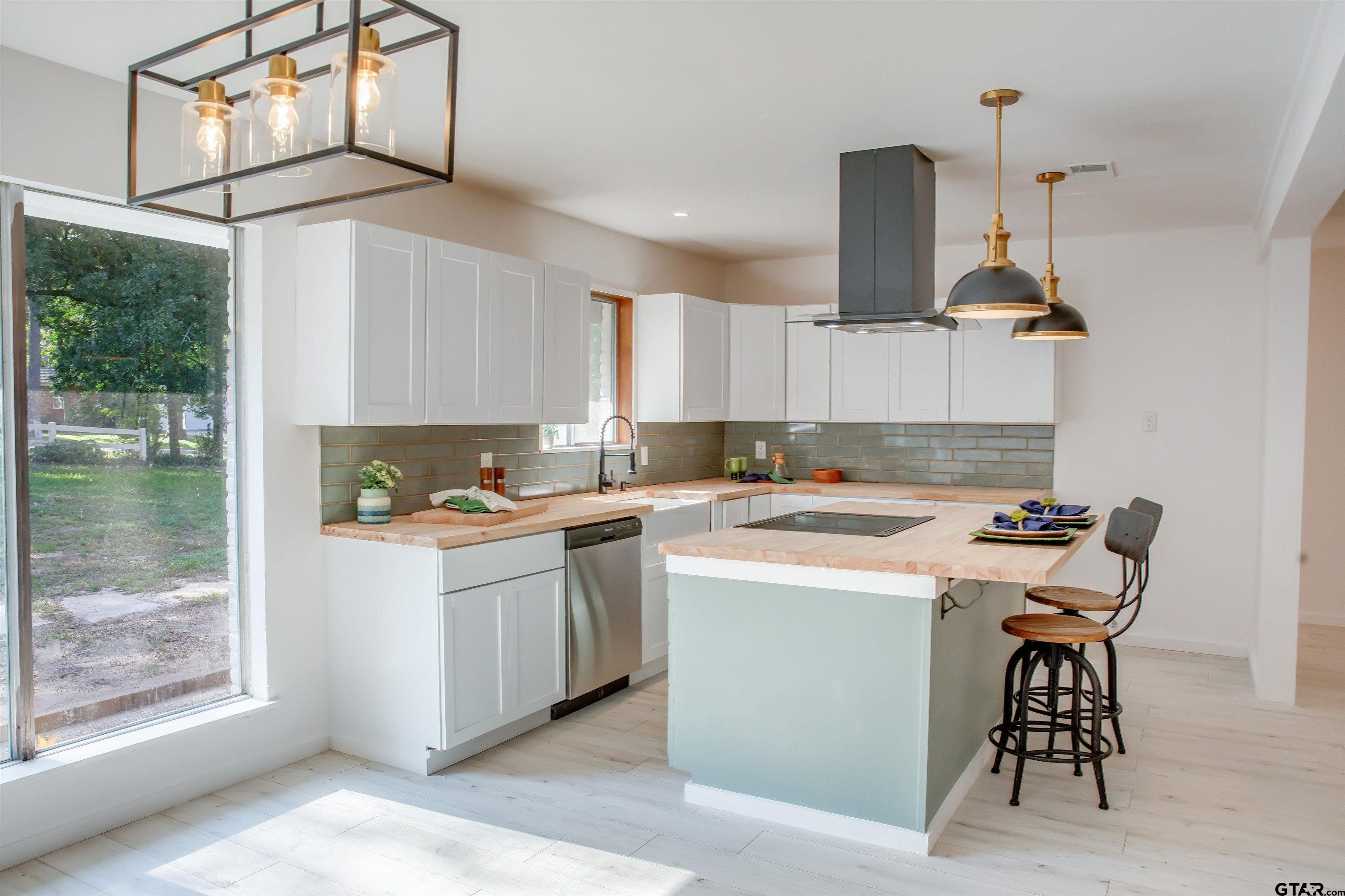 439 Lone Star Lane Hideaway, TX 75771 - Photo 15 of 36 a kitchen with a stove a sink and a refrigerator