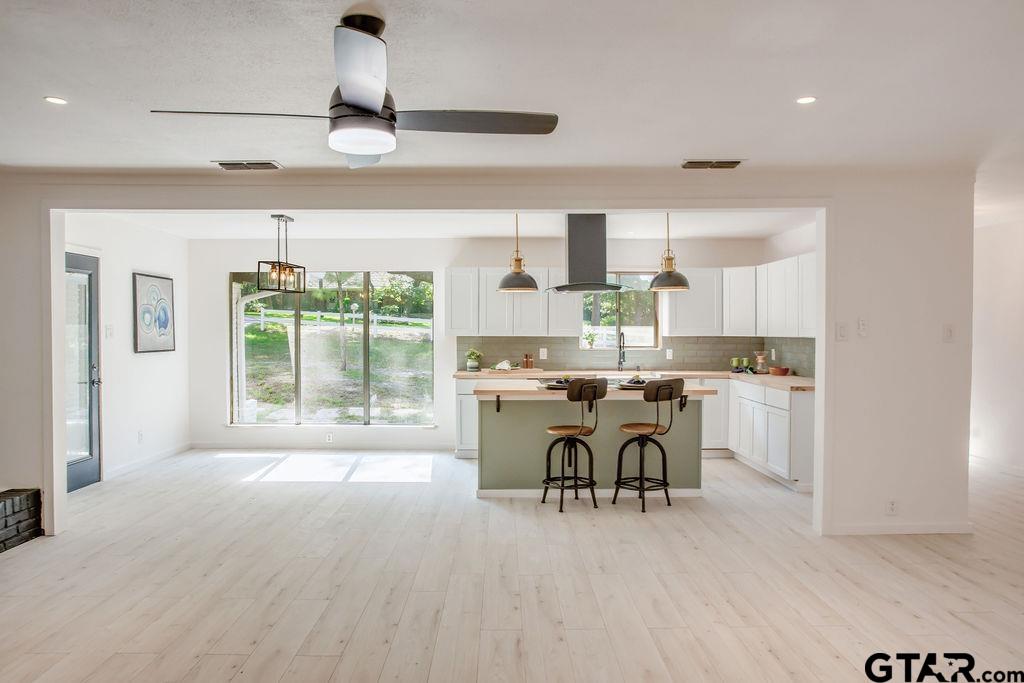 439 Lone Star Lane Hideaway, TX 75771 - Photo 20 of 36 a kitchen with a table chairs refrigerator and cabinets