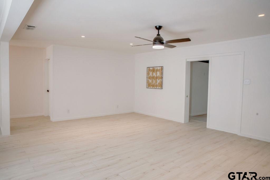 439 Lone Star Lane Hideaway, TX 75771 - Photo 21 of 36 an empty room with a ceiling fan and a window