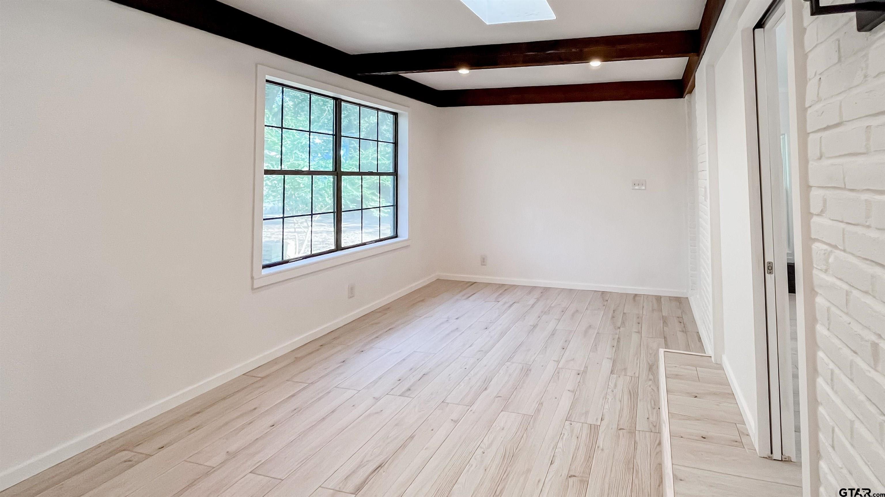 439 Lone Star Lane Hideaway, TX 75771 - Photo 23 of 36 an empty room with wooden floor and windows
