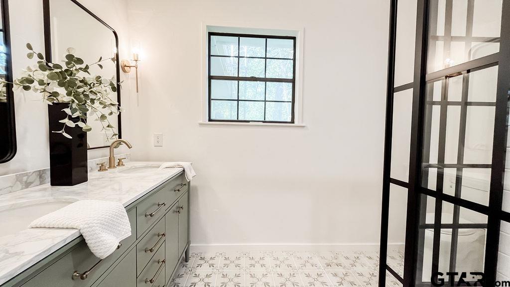 439 Lone Star Lane Hideaway, TX 75771 - Photo 25 of 36 a bathroom with a sink and a mirror